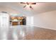 Open floorplan connects the living area to the kitchen, complete with stainless appliances and granite countertops at 8021 W Hazelwood St, Phoenix, AZ 85033