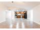 Open floorplan with tile flooring offers a view of the kitchen with stainless appliances and granite countertops at 8021 W Hazelwood St, Phoenix, AZ 85033