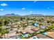 Scenic aerial view of the community featuring mountain views, lush greenery, pools, and well-kept homes at 8318 E Via De Los Libros --, Scottsdale, AZ 85258