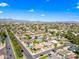 Expansive aerial view of a charming residential neighborhood with lush greenery and mountain views in the background at 8318 E Via De Los Libros --, Scottsdale, AZ 85258