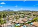 Scenic aerial view of the community featuring mountain views, lush greenery, pools, and well-kept homes at 8318 E Via De Los Libros --, Scottsdale, AZ 85258