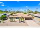 Aerial shot of a well-maintained single-story home with desert landscaping, mature trees, and a two-car carport at 8318 E Via De Los Libros --, Scottsdale, AZ 85258