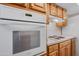 A bright kitchen features a white oven and warm-toned cabinets and countertops at 8318 E Via De Los Libros --, Scottsdale, AZ 85258