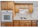 Well-equipped kitchen with modern oven and stove, complemented by ample wood cabinetry at 8318 E Via De Los Libros --, Scottsdale, AZ 85258