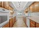 A well-lit kitchen featuring wood cabinetry, modern appliances, and a seamless flow to the adjacent dining area at 8318 E Via De Los Libros --, Scottsdale, AZ 85258