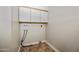 Practical laundry room with overhead cabinets, offering ample storage and maintaining an organized space for efficient household tasks at 8318 E Via De Los Libros --, Scottsdale, AZ 85258