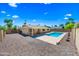 Backyard featuring a pristine pool set amidst stone landscaping and a covered patio, creating a perfect outdoor retreat at 8318 E Via De Los Libros --, Scottsdale, AZ 85258