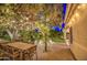 Inviting back patio featuring a pergola with string lights and a dining table for outdoor entertainment at 8748 W Maui Ln, Peoria, AZ 85381