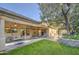 Expansive backyard with mature trees, covered patio and a vibrant green lawn, perfect for outdoor living at 8748 W Maui Ln, Peoria, AZ 85381