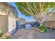 Side yard showcasing a shed, AC unit, and mature shade tree with a paver path at 8748 W Maui Ln, Peoria, AZ 85381