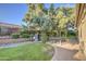 Lush backyard with a brick patio, mature trees and an outdoor dining area for entertaining at 8748 W Maui Ln, Peoria, AZ 85381