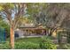 Beautiful backyard with mature trees, a covered patio and lush landscaping for relaxation and enjoyment at 8748 W Maui Ln, Peoria, AZ 85381