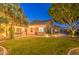 Expansive backyard with manicured lawn, string lights, and a cozy patio area at 8748 W Maui Ln, Peoria, AZ 85381