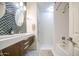 Bright bathroom with sleek vanity, dual sinks, eye-catching tilework and a separate shower/tub area at 8748 W Maui Ln, Peoria, AZ 85381