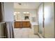 Bright bathroom has dual sinks, soaking tub, glass-enclosed shower and tile floors at 8748 W Maui Ln, Peoria, AZ 85381