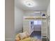 Bright bedroom featuring a lofted bed with built-in storage and shelving, and stylish decor accents at 8748 W Maui Ln, Peoria, AZ 85381
