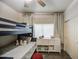 Comfortable ' room with a bunk bed, soft decor, and an organized cube storage unit at 8748 W Maui Ln, Peoria, AZ 85381