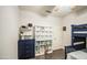 Well-organized bedroom with bunk beds, a large drawer unit and cube storage for books and toys at 8748 W Maui Ln, Peoria, AZ 85381