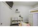 Cozy bedroom features a lofted bed with storage, white dresser, and a wall-mounted TV at 8748 W Maui Ln, Peoria, AZ 85381