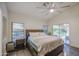 Comfortable bedroom features an open door to the backyard, a ceiling fan, and wood floors at 8748 W Maui Ln, Peoria, AZ 85381