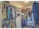 Spacious walk-in closet offers ample storage with built-in shelving and hanging rods for organized wardrobe at 8748 W Maui Ln, Peoria, AZ 85381