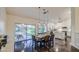 Open dining area with dark wood floors, a modern light fixture, and outdoor patio access at 8748 W Maui Ln, Peoria, AZ 85381