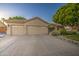 Single-Gathering home featuring a three-car garage, desert landscaping, and tile roof at 8748 W Maui Ln, Peoria, AZ 85381