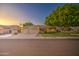 Spacious home with a three-car garage, mature trees, and well-maintained landscaping at 8748 W Maui Ln, Peoria, AZ 85381