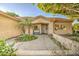Inviting front entry featuring a bench, mature palm trees and vibrant landscaping at 8748 W Maui Ln, Peoria, AZ 85381