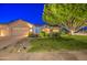 Lovely single-story home with a well-maintained lawn, desert landscaping, and a convenient three-car garage at 8748 W Maui Ln, Peoria, AZ 85381