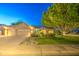 Inviting single-story home with a lush green lawn, desert landscaping, and a spacious three-car garage at 8748 W Maui Ln, Peoria, AZ 85381