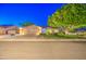 Beautiful single-story home with a manicured lawn, desert landscaping, and an attached three-car garage at 8748 W Maui Ln, Peoria, AZ 85381