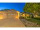 Charming single-story home with a well-manicured lawn, desert landscaping, and a three-car garage at 8748 W Maui Ln, Peoria, AZ 85381
