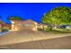 Welcoming single-story home with a spacious driveway, desert landscaping, and an attached three-car garage at 8748 W Maui Ln, Peoria, AZ 85381