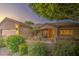 Inviting single-story home showcasing lush landscaping and a charming front entrance at 8748 W Maui Ln, Peoria, AZ 85381