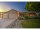 Landscaped front yard with mature trees and a well-maintained lawn at 8748 W Maui Ln, Peoria, AZ 85381