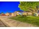 Inviting home featuring mature landscaping, a spacious driveway, and an attached three-car garage at 8748 W Maui Ln, Peoria, AZ 85381