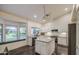 Bright kitchen with white cabinets, granite countertops, and island at 8748 W Maui Ln, Peoria, AZ 85381