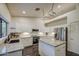 Spacious kitchen with white cabinetry, granite countertops, and modern appliances at 8748 W Maui Ln, Peoria, AZ 85381