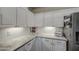 Kitchen features white cabinets and granite countertops at 8748 W Maui Ln, Peoria, AZ 85381