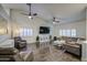 Spacious living room featuring vaulted ceiling, modern ceiling fans, and plantation shutters at 8748 W Maui Ln, Peoria, AZ 85381