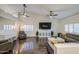 Bright living room with plantation shutters, ceiling fans, hardwood floors and stylish decor at 8748 W Maui Ln, Peoria, AZ 85381
