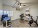 Spacious home office features wood floors, two desks, exercise equipment, and ample natural light at 8748 W Maui Ln, Peoria, AZ 85381
