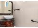 Stylish powder room featuring a vessel sink on a dark wood vanity and unique fixtures at 8795 W Windsor Dr, Peoria, AZ 85381