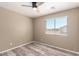 A bedroom with wood-look floors and a large window providing natural light at 8795 W Windsor Dr, Peoria, AZ 85381