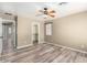 Comfortable bedroom featuring modern flooring, a ceiling fan, and a walk-in closet at 8795 W Windsor Dr, Peoria, AZ 85381