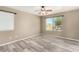 Inviting bedroom with wood-look floors, neutral tones, and ample natural light from large windows at 8795 W Windsor Dr, Peoria, AZ 85381