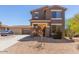 Inviting two-story home featuring a neutral color, well-kept landscaping, and a spacious driveway leading to a three-car garage at 8795 W Windsor Dr, Peoria, AZ 85381