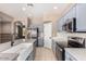 Updated kitchen featuring stainless steel appliances, blue cabinetry, and a farmhouse sink at 8795 W Windsor Dr, Peoria, AZ 85381