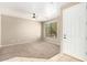 Bright, open living room features neutral carpet, a ceiling fan, and ample natural light from a large window at 8795 W Windsor Dr, Peoria, AZ 85381